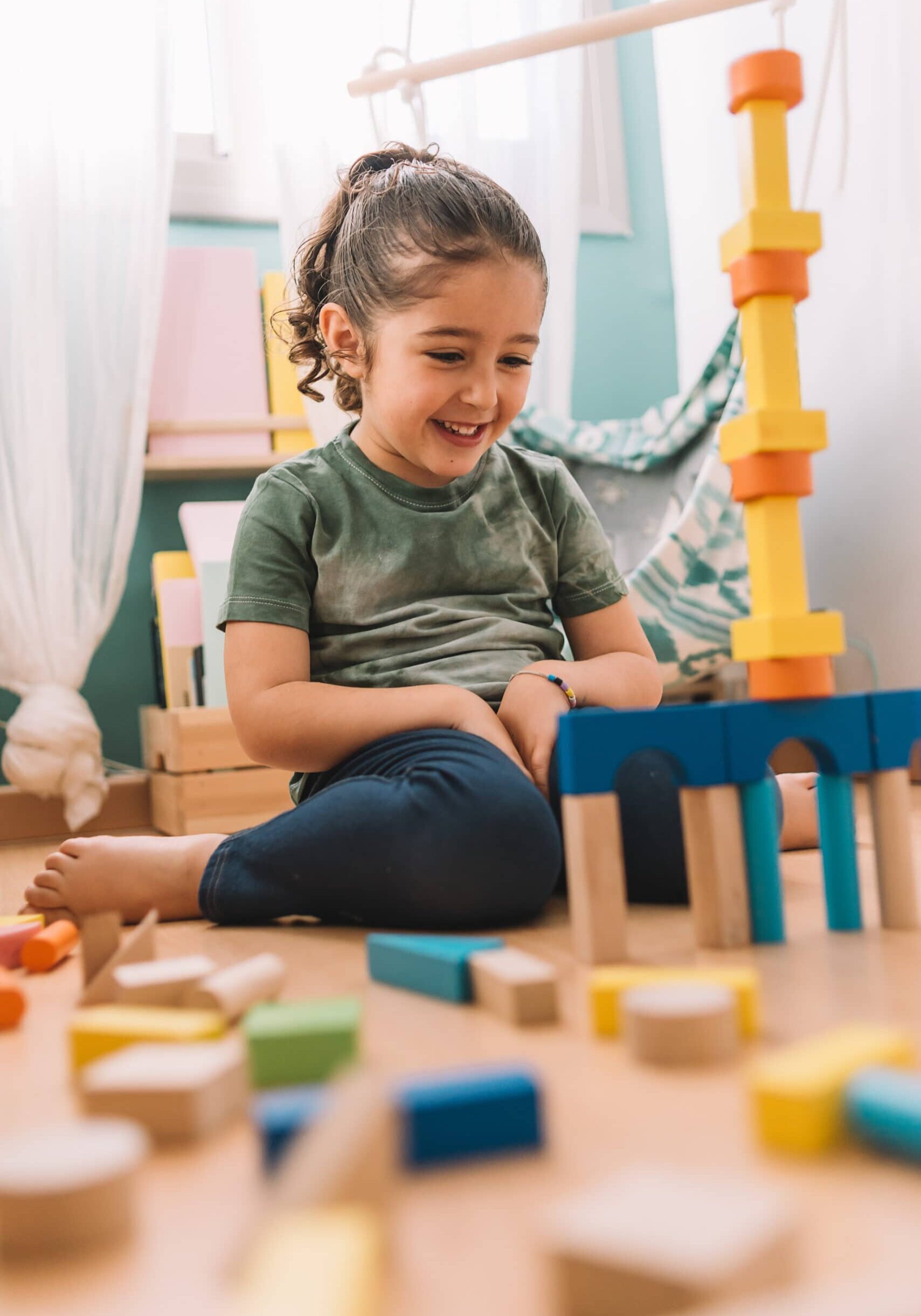 Happy Girl Building With Colorful Wooden Blocks