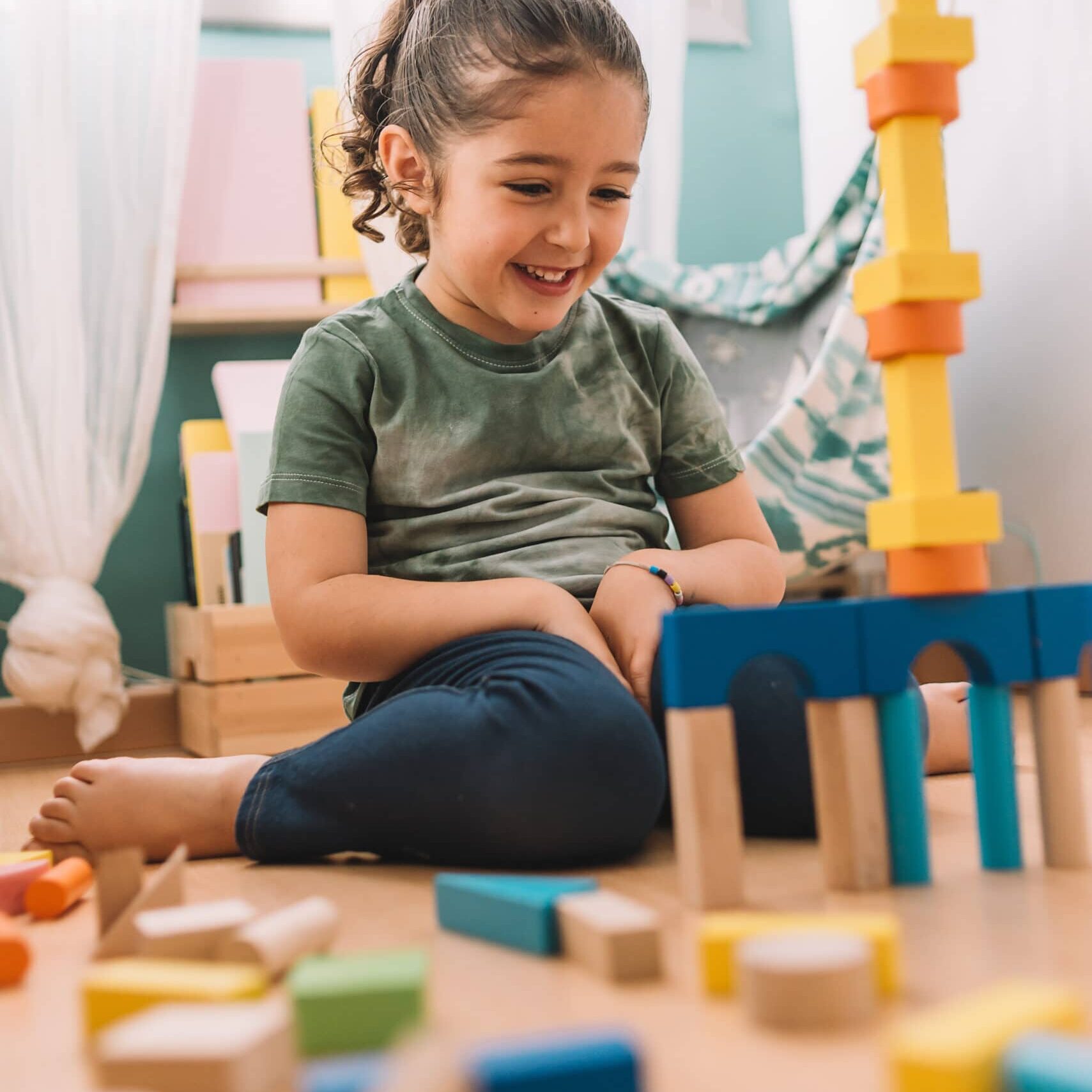 Happy Girl Building With Colorful Wooden Blocks